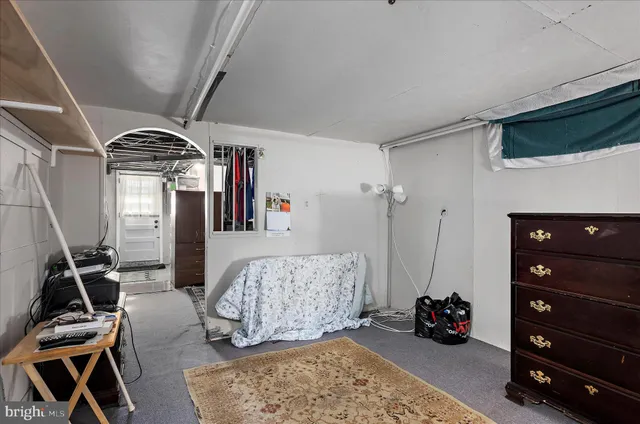 a bedroom with a bed and a tv