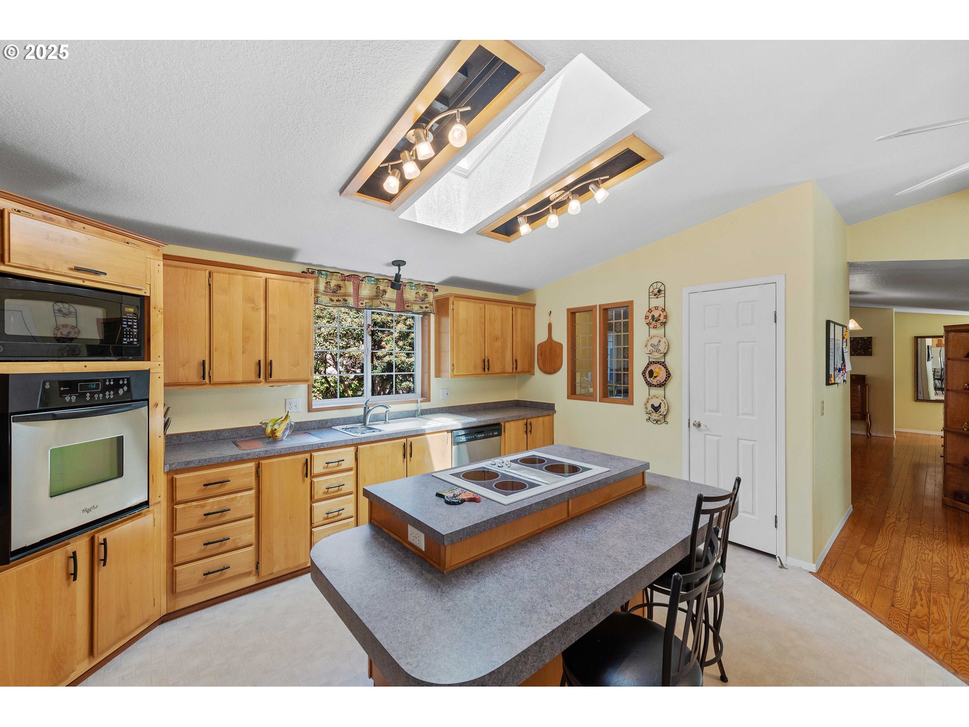 1615 Kristi Loop Lakeside, OR 97449 - Photo 11 of 38 a kitchen with sink cabinets and wooden floor