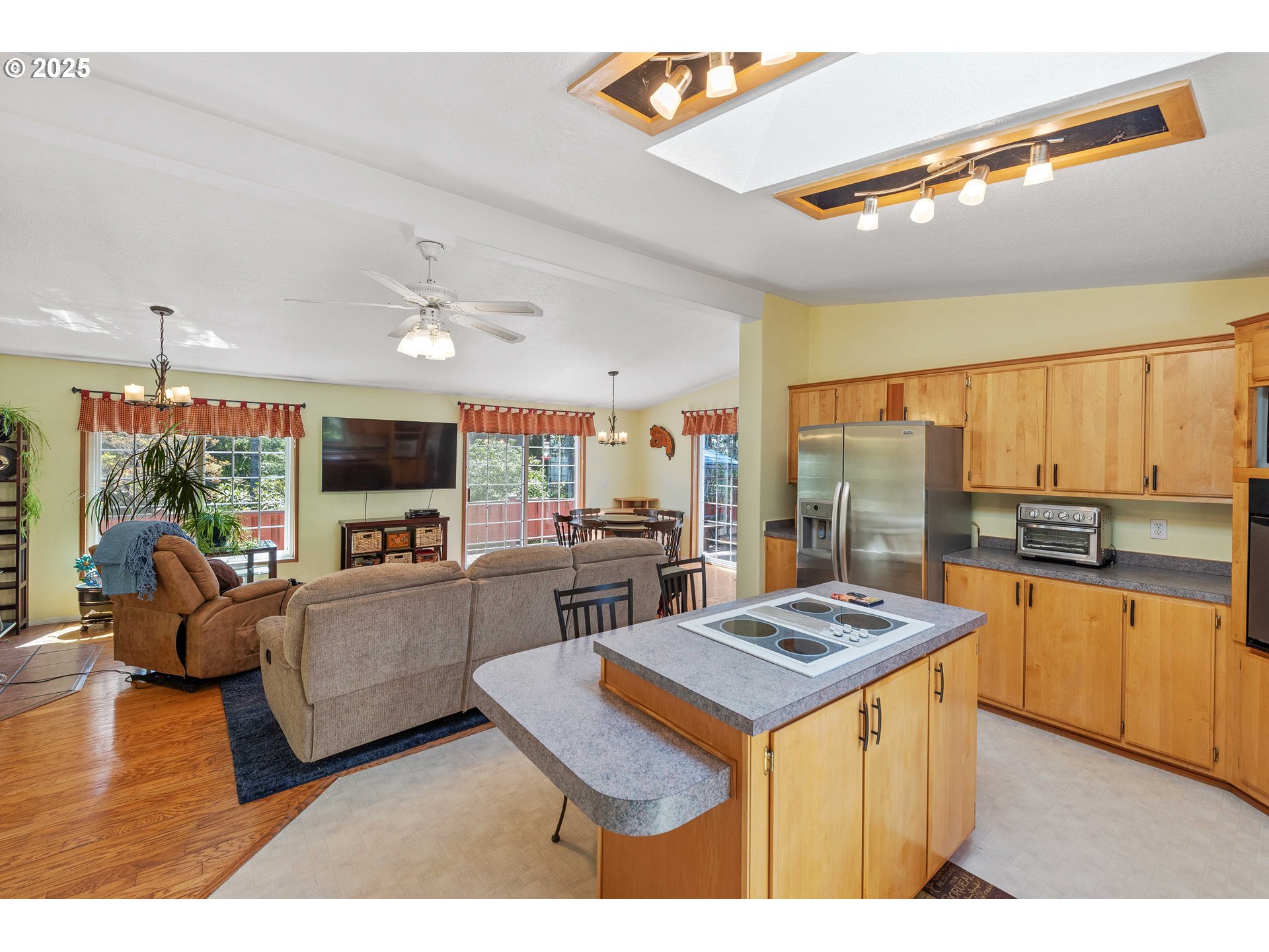 1615 Kristi Loop Lakeside, OR 97449 - Photo 12 of 38 a open kitchen with stainless steel appliances kitchen island granite countertop a sink and a stove