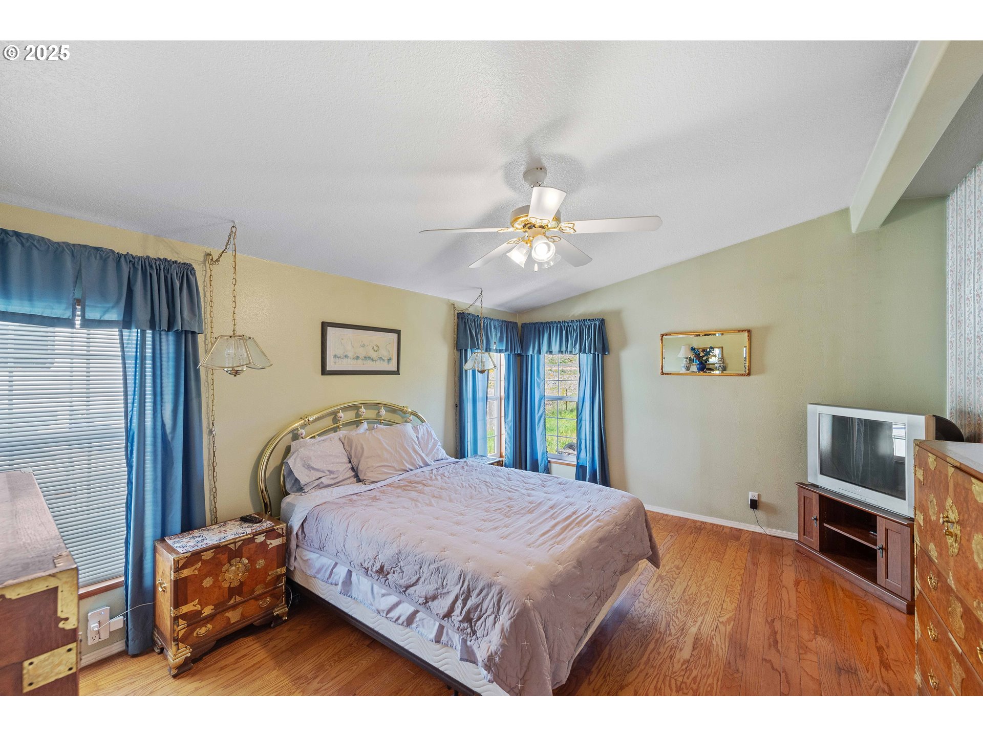 1615 Kristi Loop Lakeside, OR 97449 - Photo 16 of 38 a bedroom with a bed and a flat screen tv