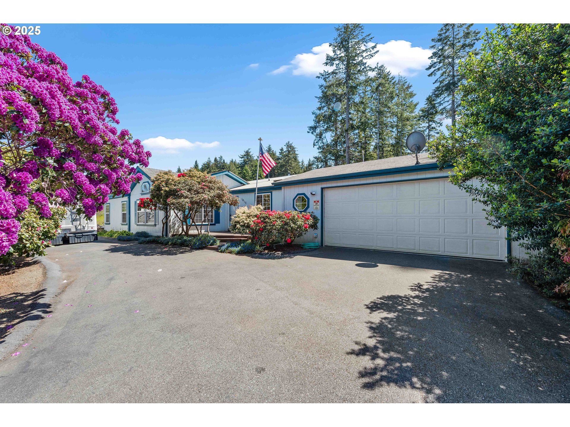1615 Kristi Loop Lakeside, OR 97449 - Photo 2 of 38 a couple of flower plants sitting in front of a house