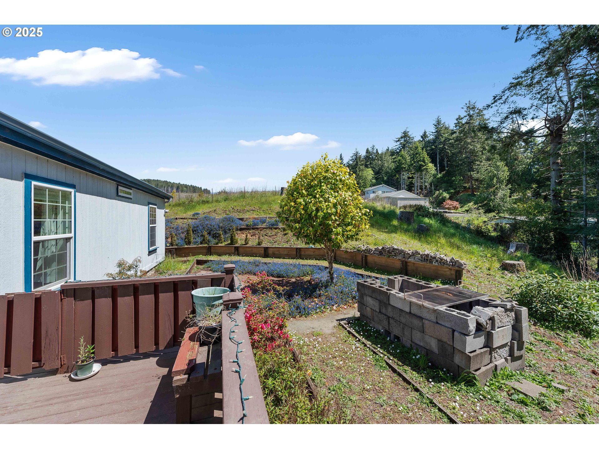 1615 Kristi Loop Lakeside, OR 97449 - Photo 30 of 38 a view of a backyard with couches under an umbrella