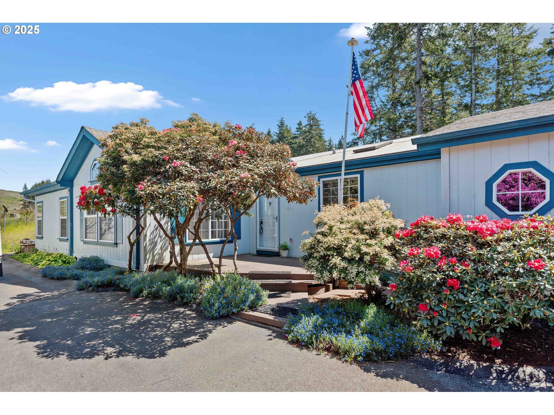 1615 Kristi Loop Lakeside, OR 97449 - Photo 4 of 38 a view of a house that has a flower garden