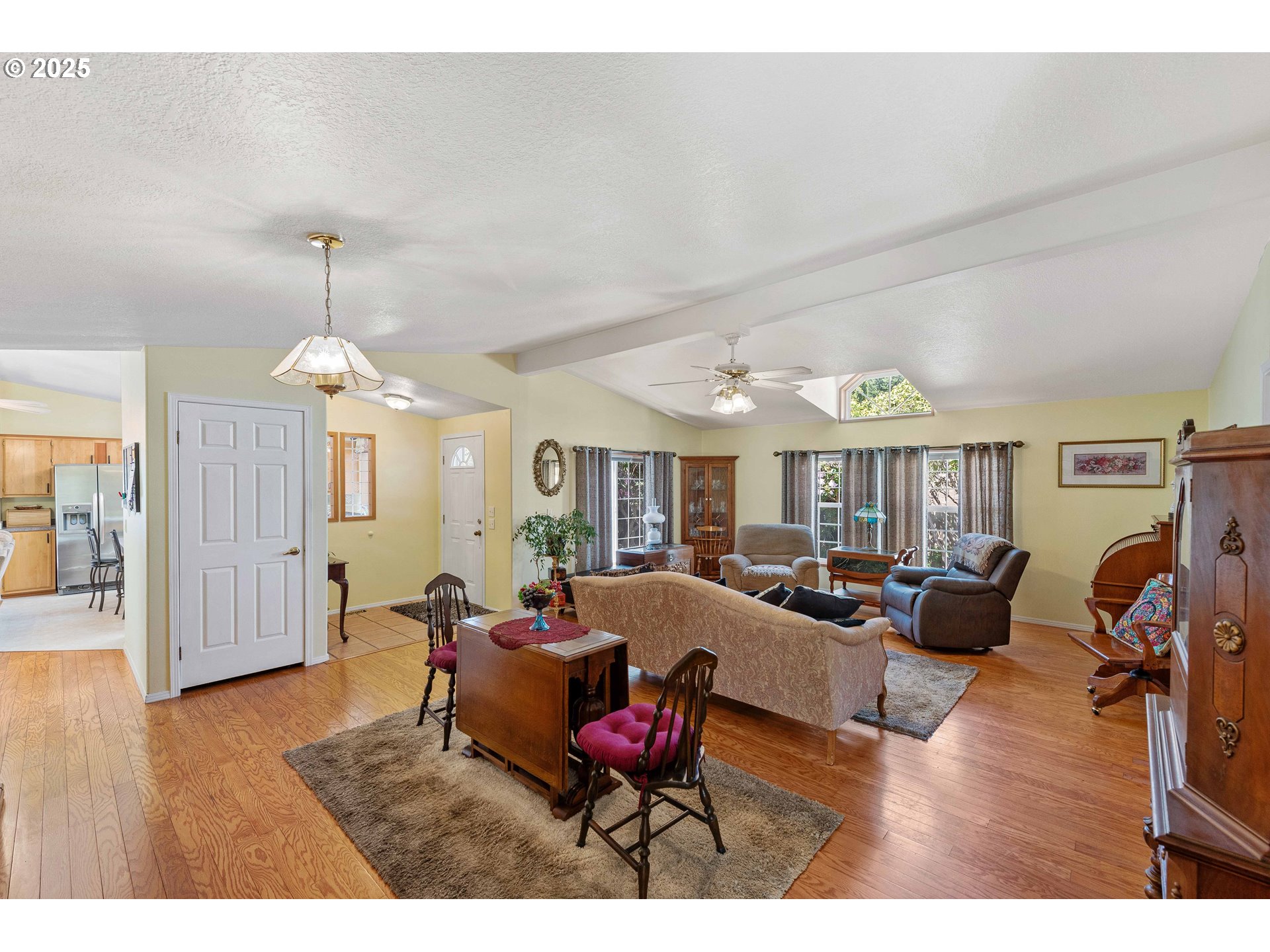 1615 Kristi Loop Lakeside, OR 97449 - Photo 6 of 38 a living room with furniture a fireplace and wooden floor