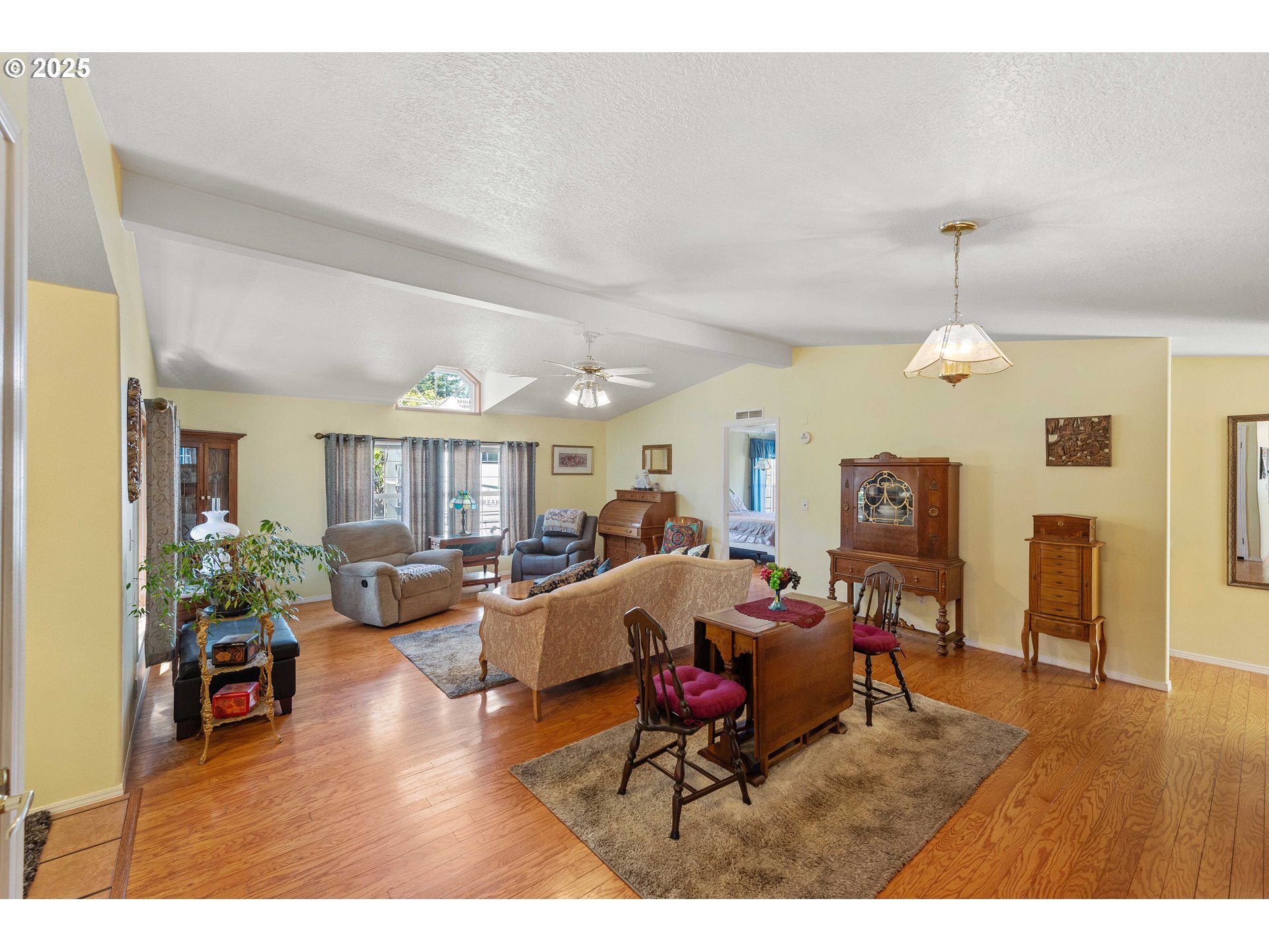 1615 Kristi Loop Lakeside, OR 97449 - Photo 7 of 38 a living room with furniture a dining table and a fireplace