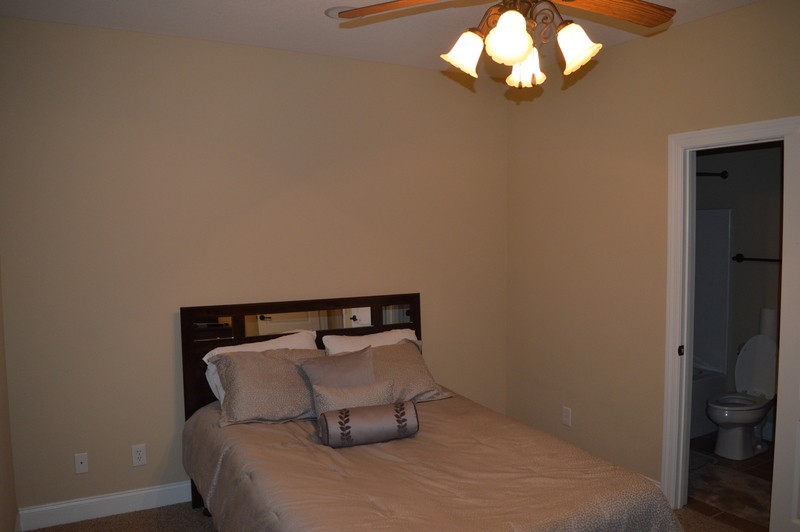 812 Little Springs Road Clarksville, TN 37040 - Photo 11 of 19 a bedroom with a bed and a chandelier