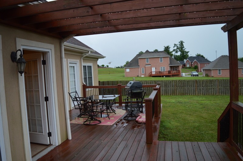 812 Little Springs Road Clarksville, TN 37040 - Photo 16 of 19 a view of a patio with dining table and chairs with wooden floor and fence