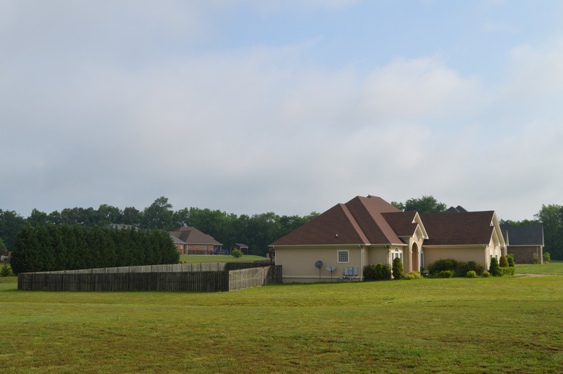 812 Little Springs Road Clarksville, TN 37040 - Photo 19 of 19 a view of a big house with a big yard and large trees