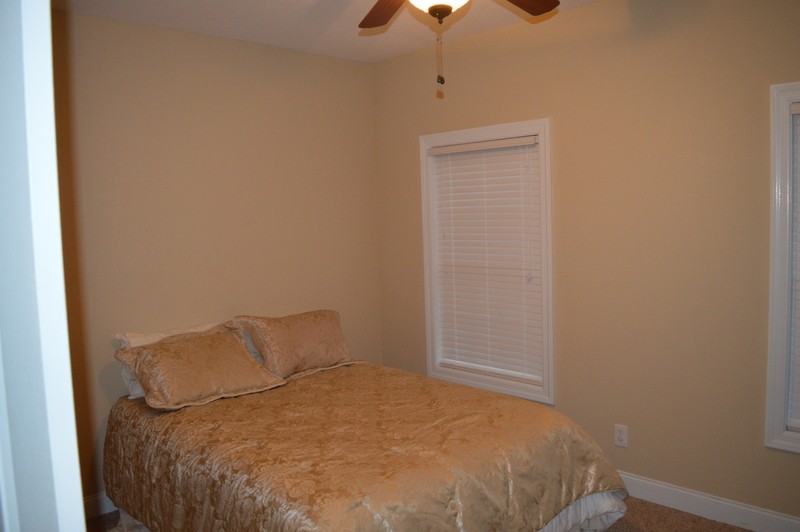 812 Little Springs Road Clarksville, TN 37040 - Photo 10 of 19 a bedroom with a bed and a chandelier fan
