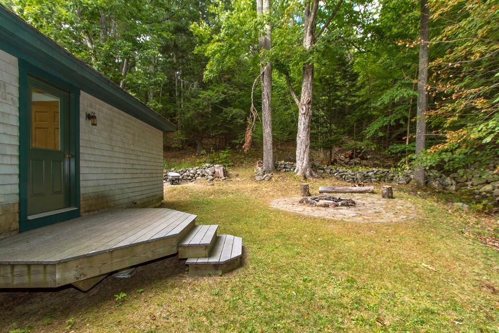 447 Molyneaux Road Camden, ME 04843 - Photo 10 of 12 Back exterior, stonewalls and fire pit