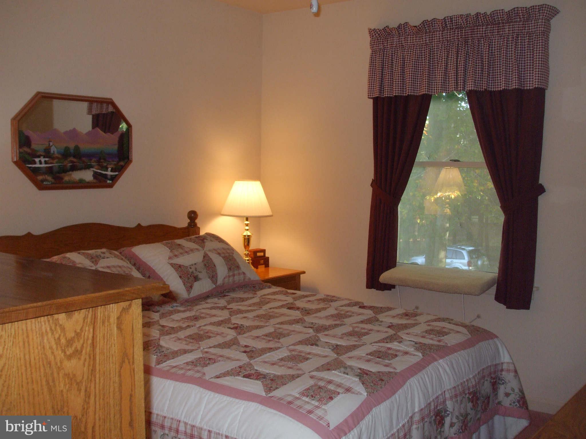595 Ridgewood Road Bel Air, MD 21014 - Photo 22 of 26 a bedroom with a bed and a painting on the wall