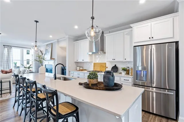 a kitchen with refrigerator a table and chairs