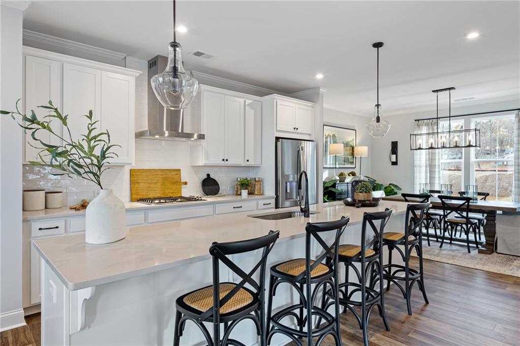 821 Cameron Trail Acworth, GA 30102 - Photo 15 of 30 a kitchen with stainless steel appliances a table chairs refrigerator and microwave
