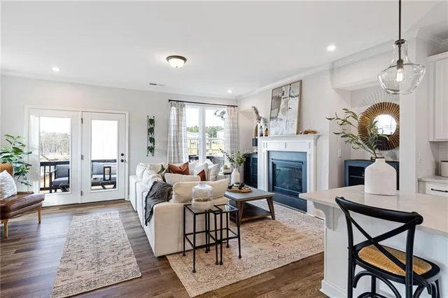 a living room with fireplace furniture and a wooden floor