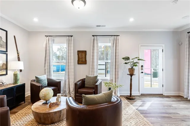 a living room with furniture and a potted plant