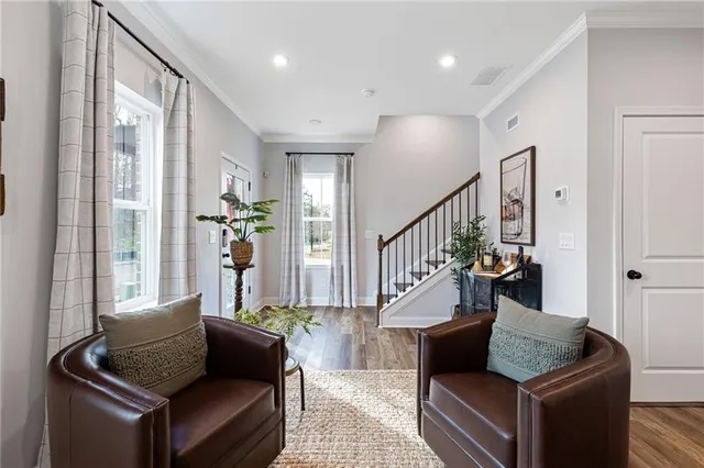 a living room with furniture and a potted plant