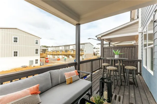 a balcony with furniture and view of kitchen