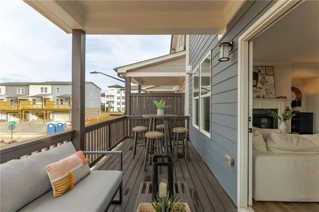 a view of a living room and a balcony with furniture