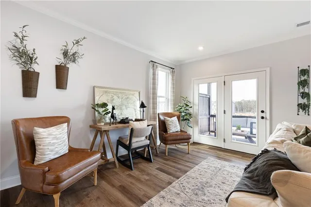 a living room with furniture and wooden floor