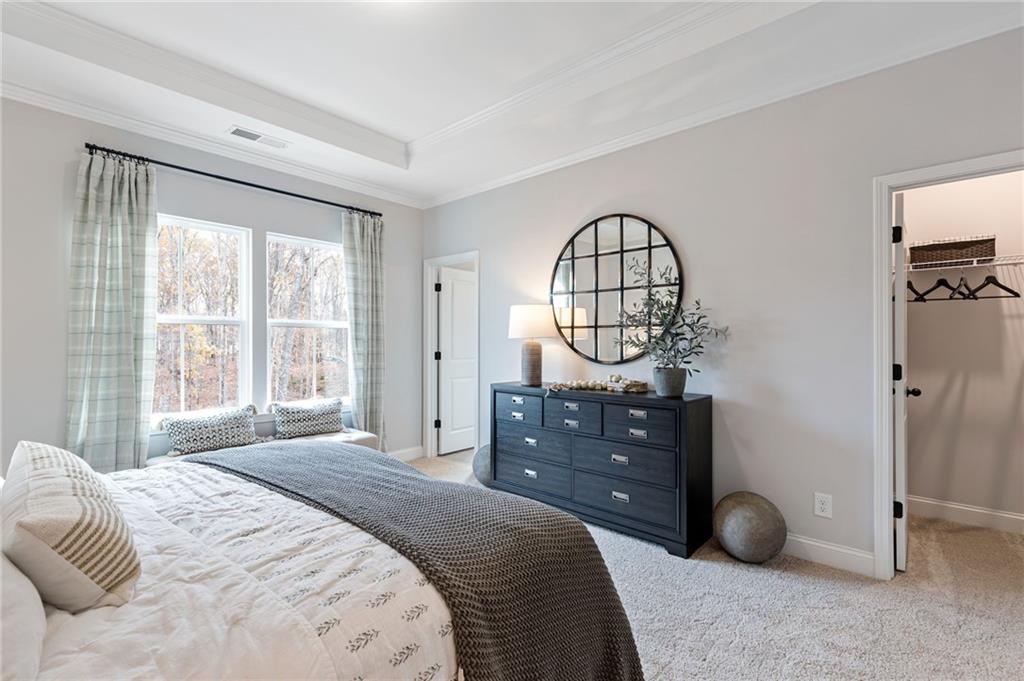 821 Cameron Trail Acworth, GA 30102 - Photo 9 of 30 a bedroom with a bed a mirror on table and a large window