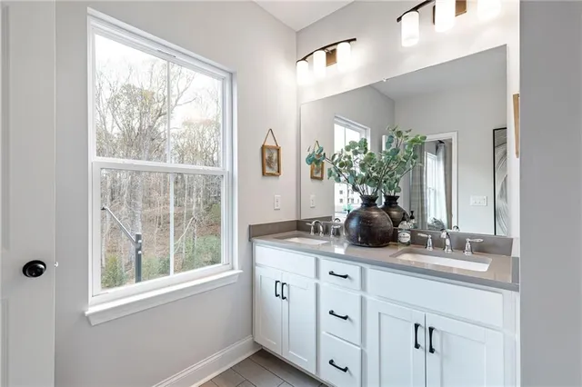 a bathroom with a double vanity sink and mirror