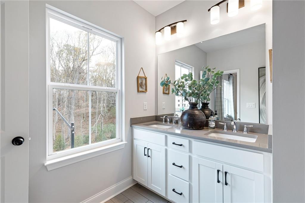 821 Cameron Trail Acworth, GA 30102 - Photo 10 of 30 a bathroom with a double vanity sink and mirror