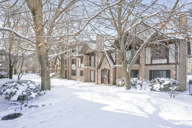 a front view of a building with snow on the road