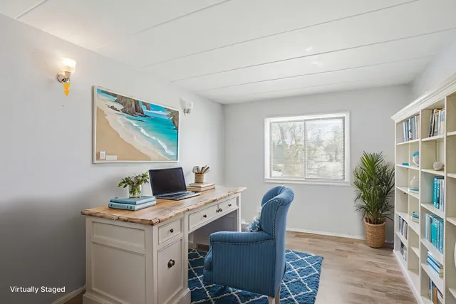 a view of a workspace with furniture and a potted plant