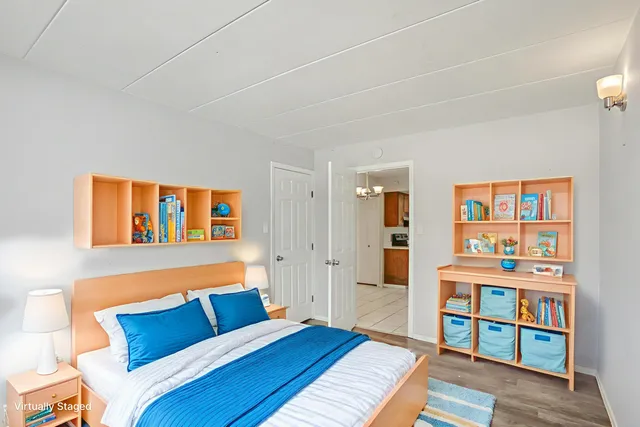 a bedroom with furniture and a book shelf