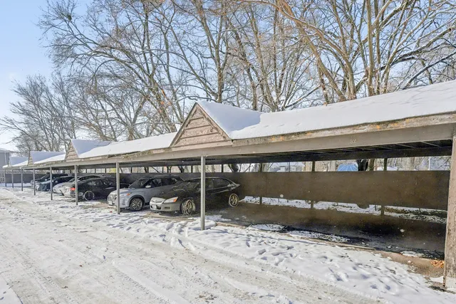 a view of a house with a yard covered in snow