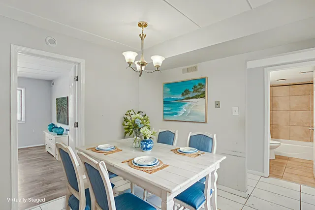 a view of a dining room with furniture and chandelier
