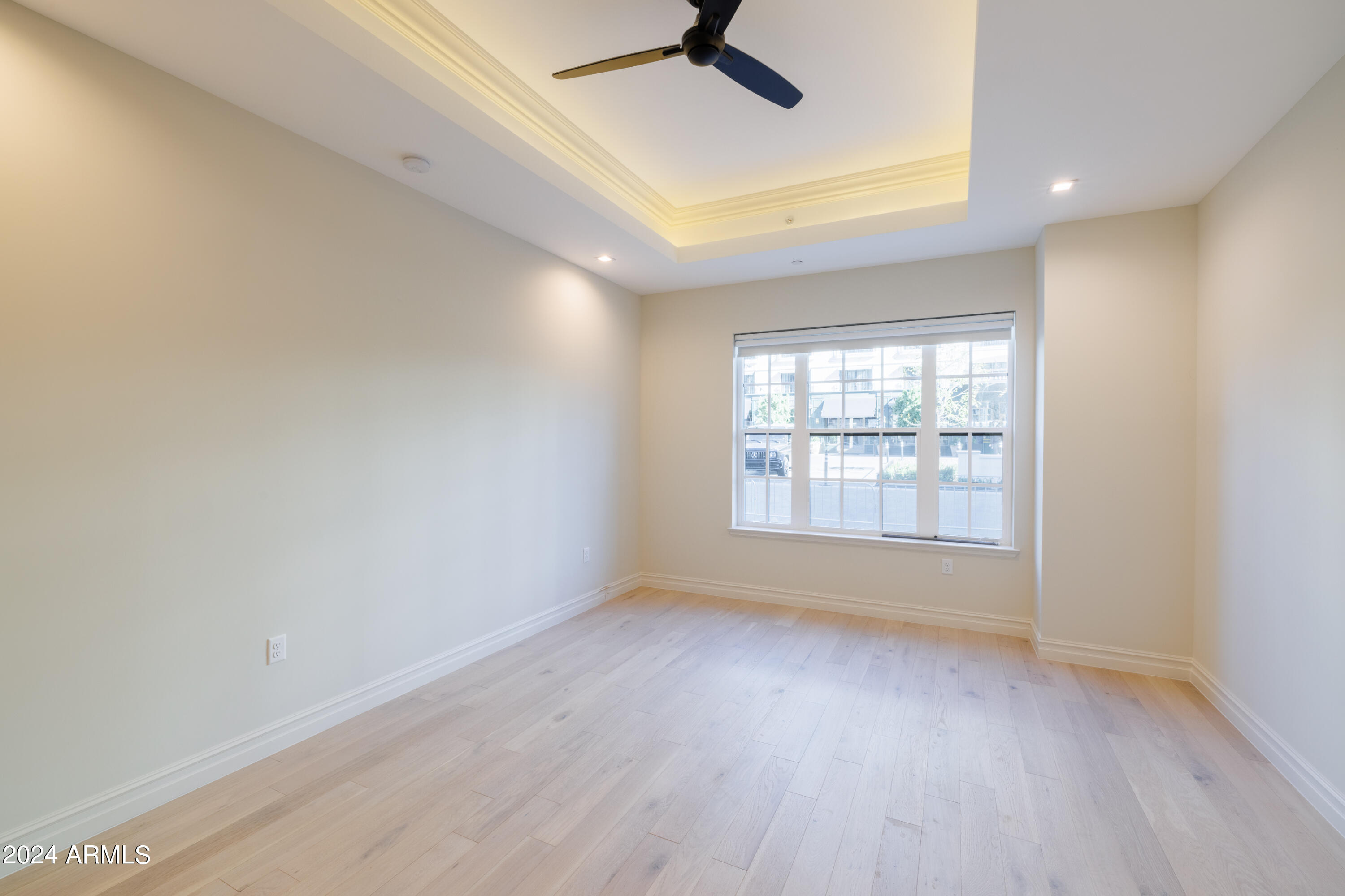 4240 East Camelback Road, Unit 508 Phoenix, AZ 85018 - Photo 11 of 27 an empty room with a window and a ceiling fan
