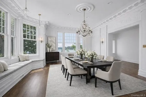 a view of a dining room with furniture and chandelier