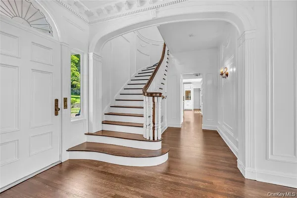 a view of entryway with wooden floor and stairs