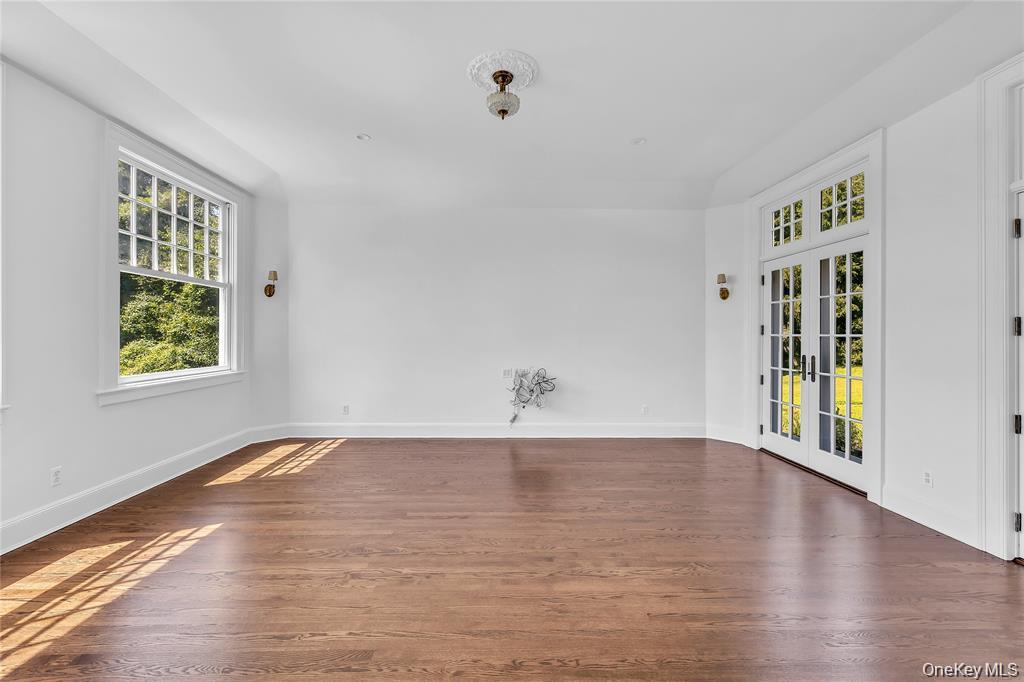 158 East Shore Road Huntington Bay, NY 11743 - Photo 19 of 50 a view of an empty room with window and wooden floor