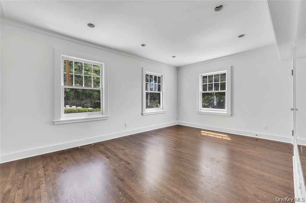 158 East Shore Road Huntington Bay, NY 11743 - Photo 23 of 50 a view of an empty room with wooden floor and windows