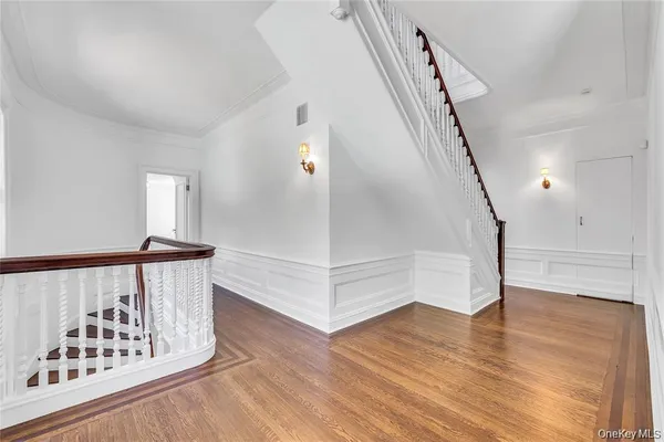 a view of entryway with stairs and wooden floor