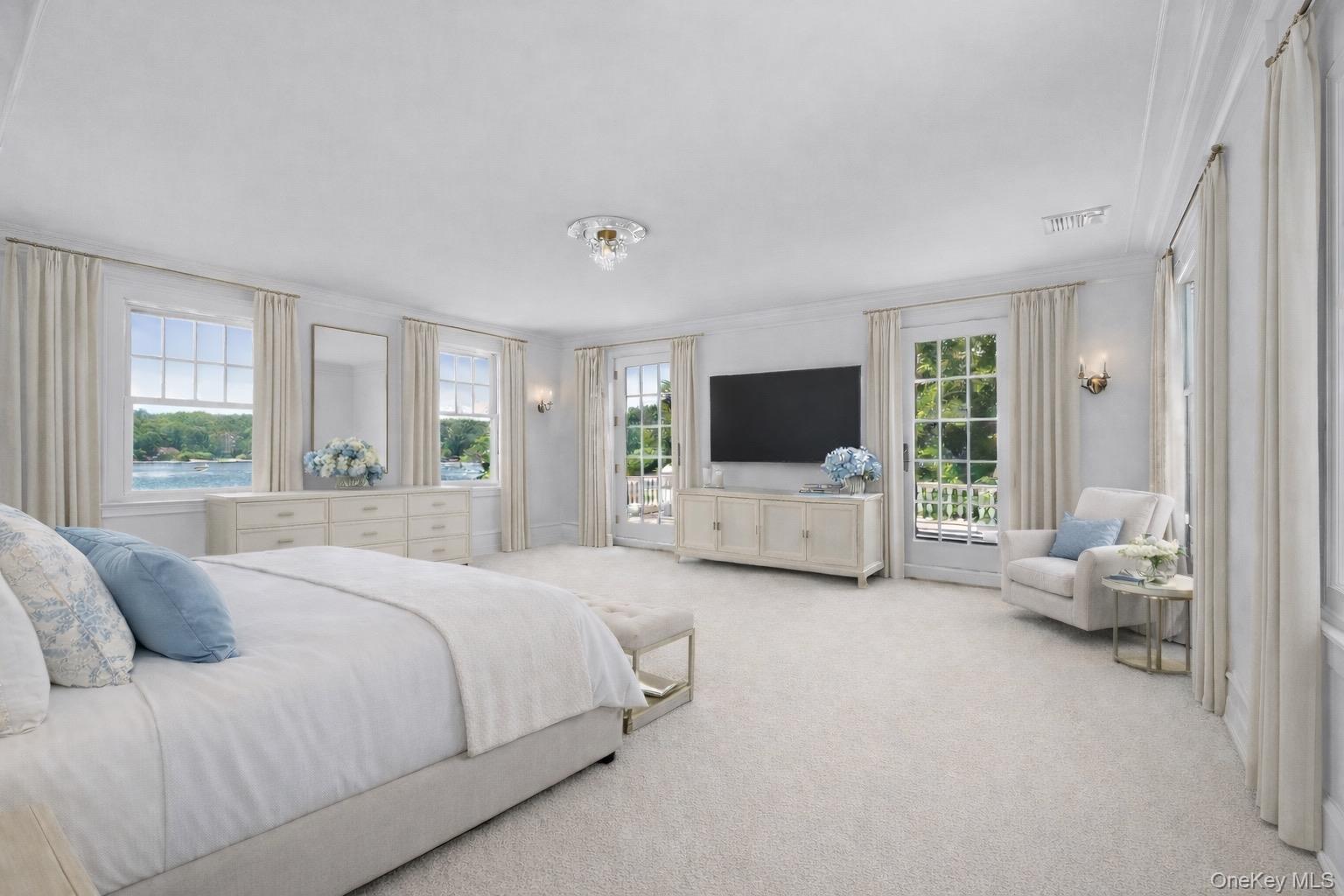 158 East Shore Road Huntington Bay, NY 11743 - Photo 26 of 50 a spacious bedroom with a bed and a flat screen tv