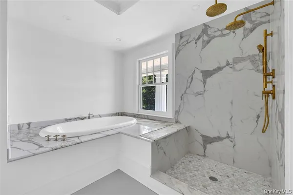 a bathroom with a granite countertop sink a toilet and shower