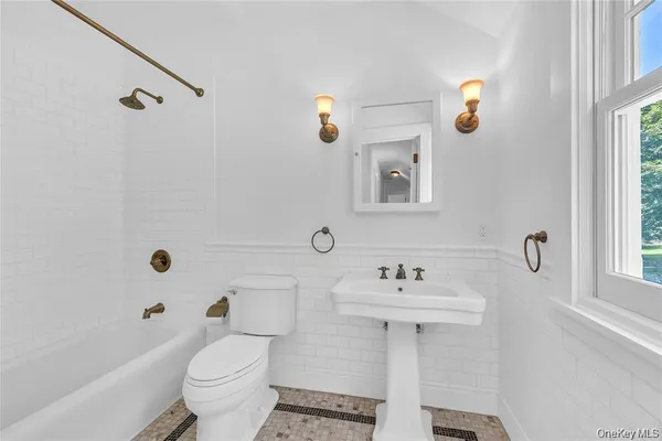 a bathroom with a sink toilet tub and shower