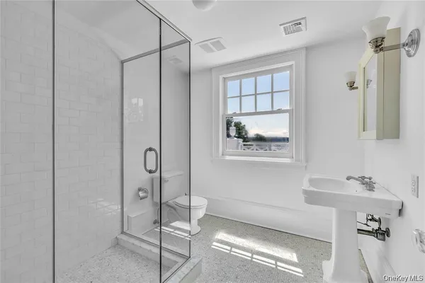 a bathroom with a shower and a sink