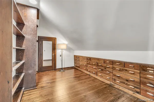 a view of an empty room and wooden floor