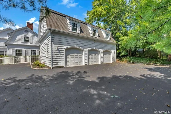 a view of a house with a backyard and parking
