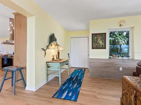 a living room with furniture and a floor to ceiling window
