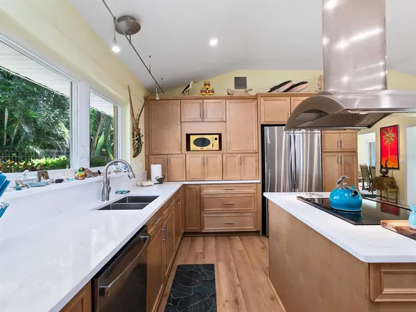 a kitchen with a sink a stove and chairs