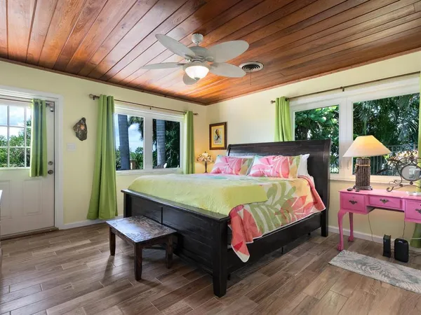 a bedroom with two beds and a large window