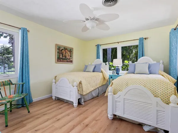 a spacious bedroom with a bed and a large mirror