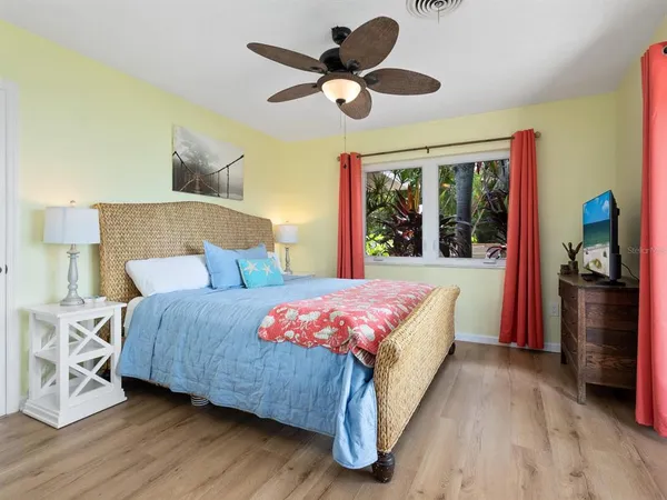 a view of a patio with table and chairs potted plants and palm tree