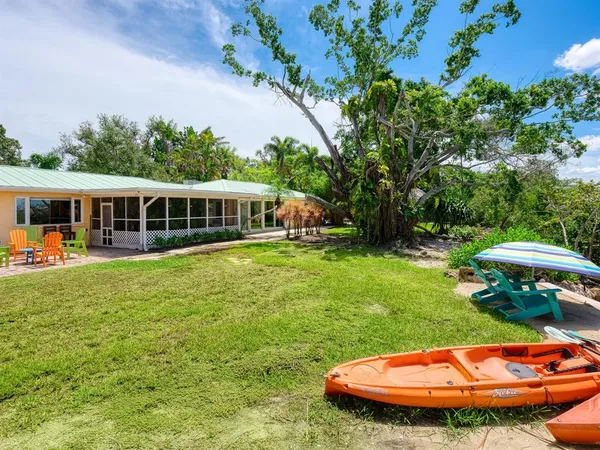a view of a chairs and table in a backyard
