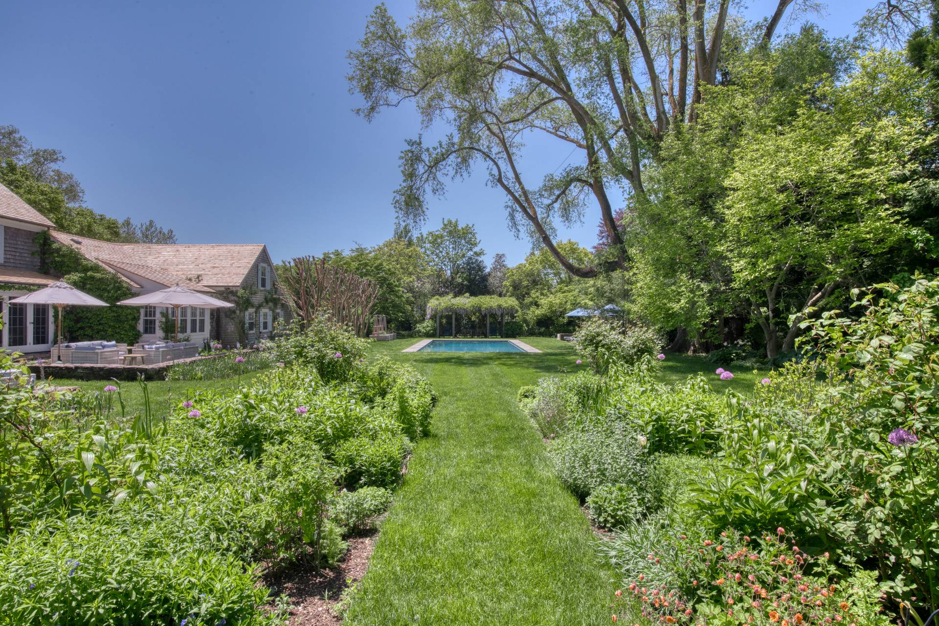 46 Westminster Road Water Mill, NY 11976 - Photo 23 of 28 a backyard of a house with lots of green space and fountain